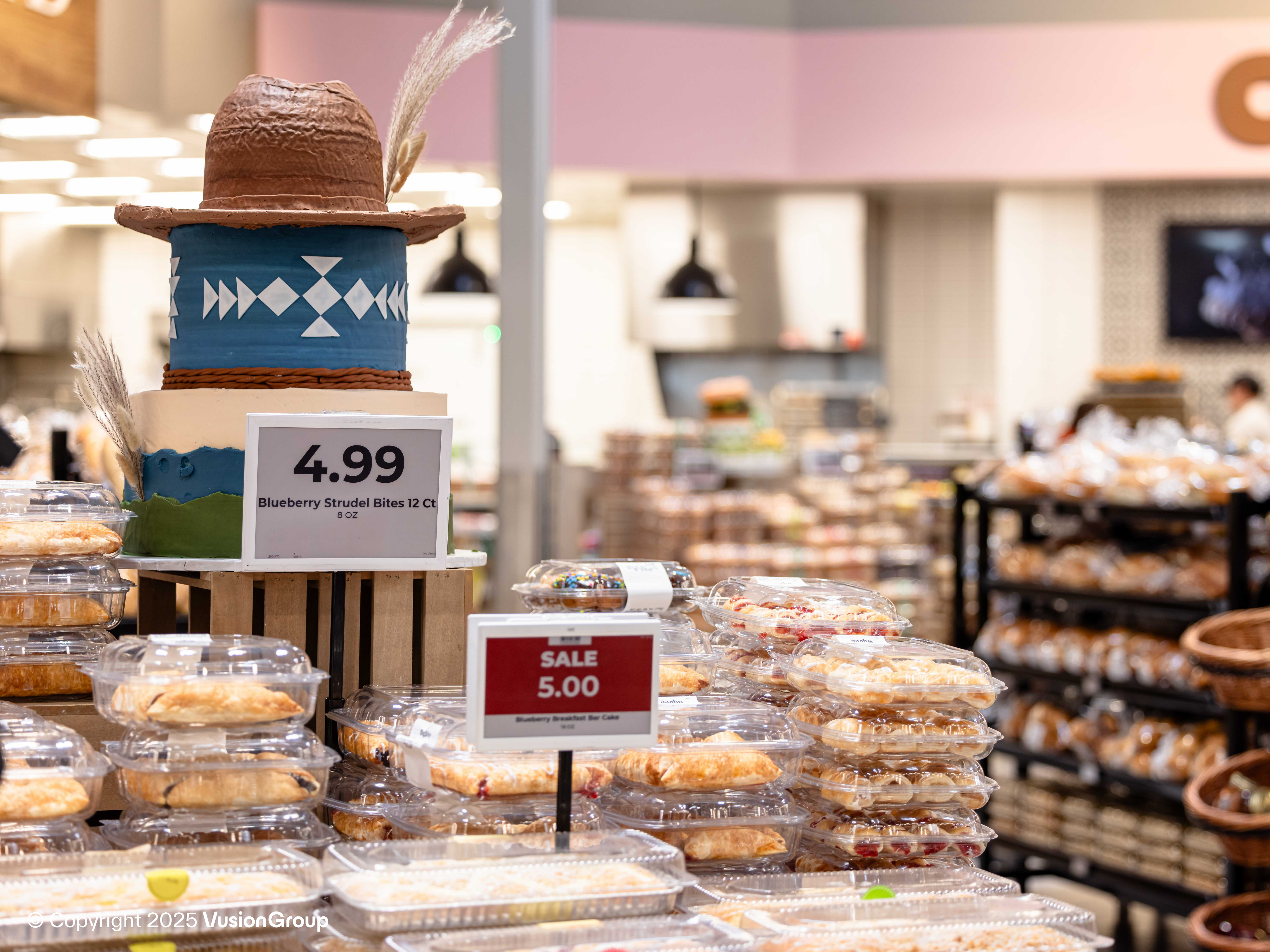 Cake and pastry section featuring stand-mounted electronic price label reading 4.99, powered by DUMAC / SES-imagotag.